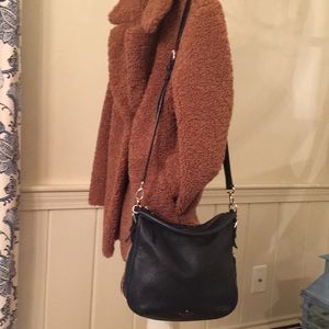 Soft supple black leather Kate Spade shoulder bag wit gold zipper detail.
